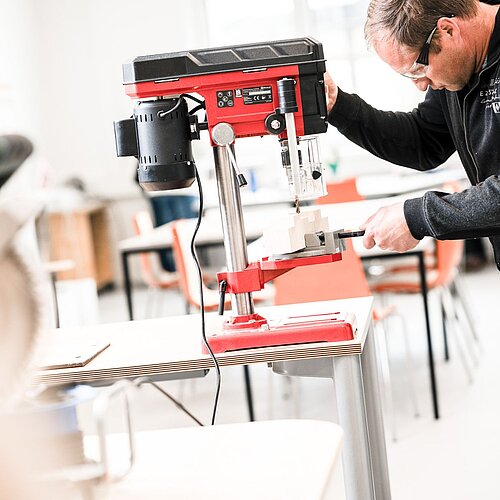Man working in the new employment workshop on a machine