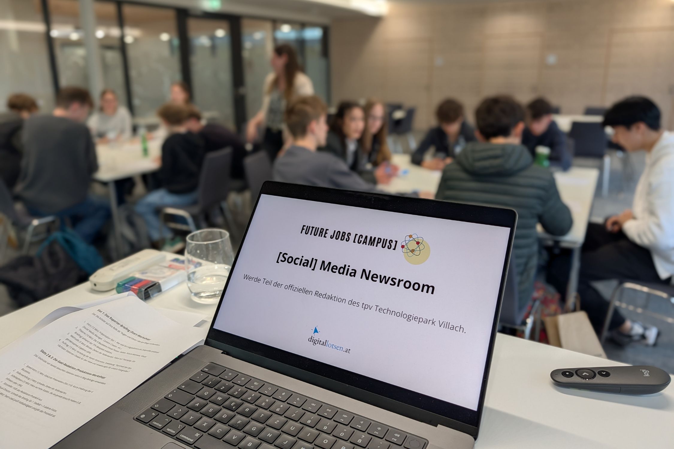 Workshop-Präsentation mit Jugendlichen im Hintergrund