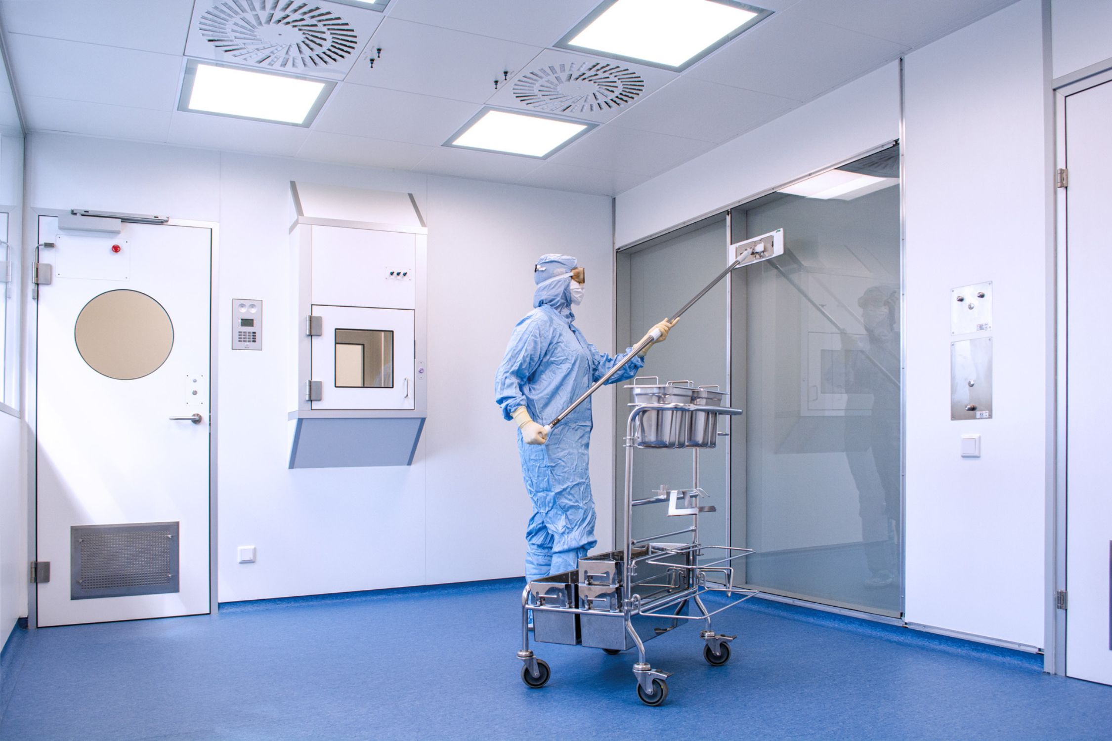Employee is cleaning a cleanroom