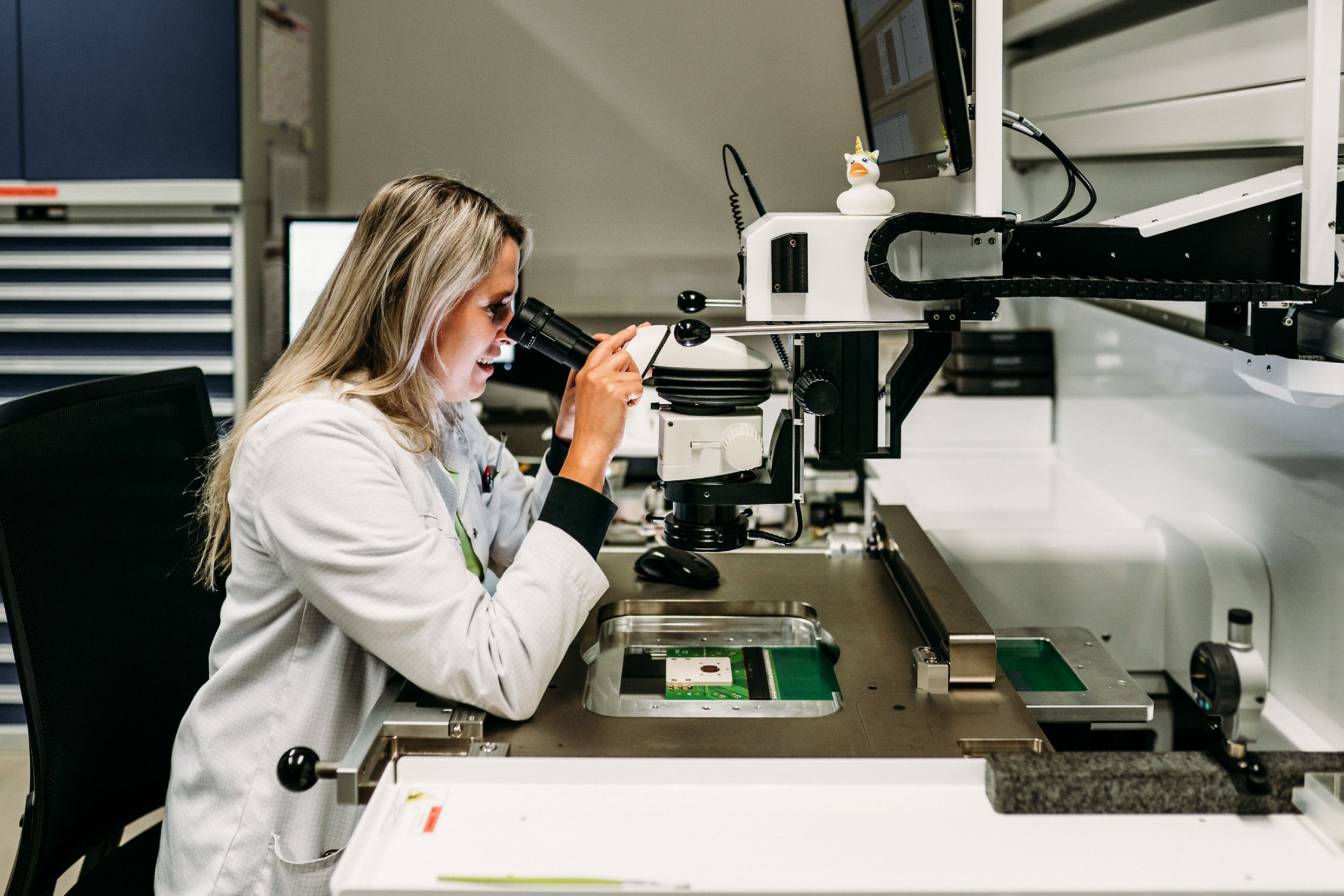 .I.P.S. employee looking intently through a microscope