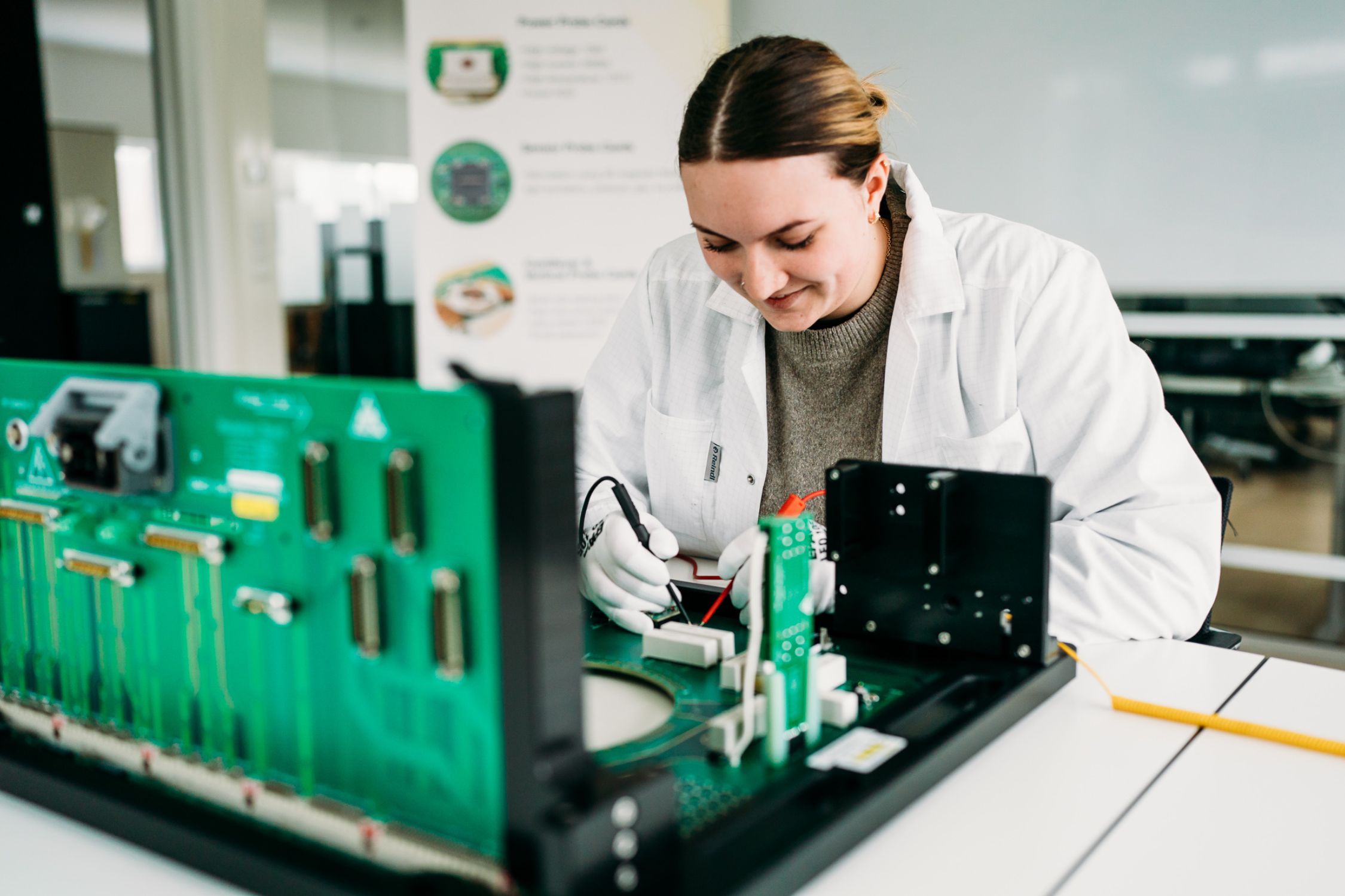 T.I.P.S. employee working on a component in production